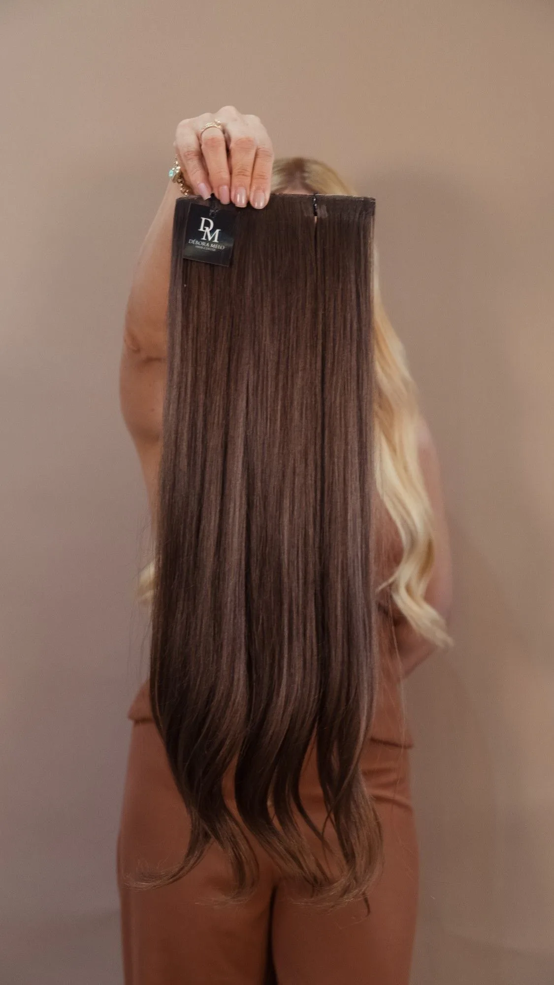 Mecha de cabelo castanho longo suspensa pela faixa, mostrando o comprimento completo.
